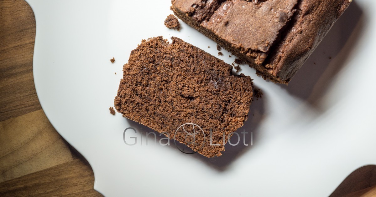 A chocolate cake slice, next to the loaf cake